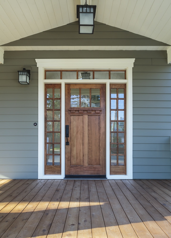 wooden front door under a covered porch