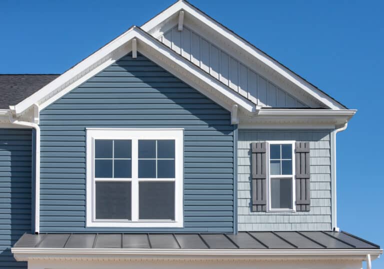 double pane window on a house with blue siding