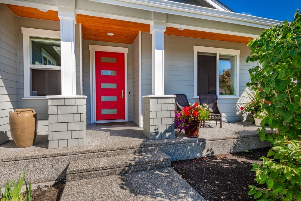 red colored steel entry door with decorative window slits