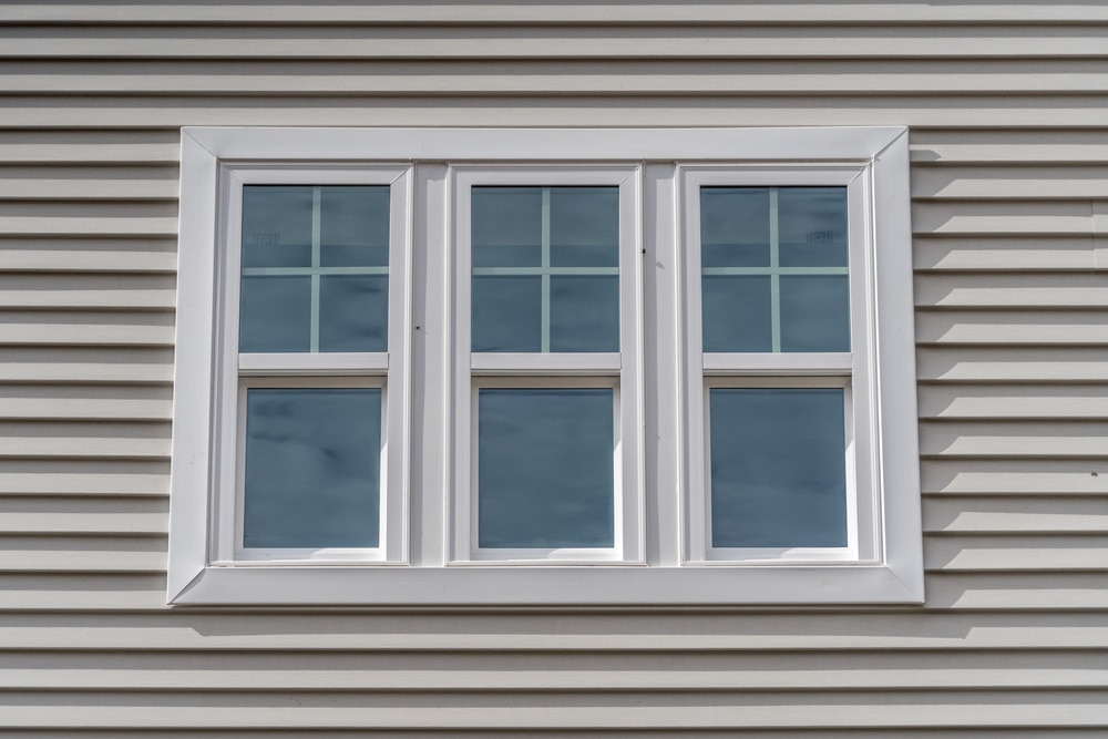 triple hung window with white sashes